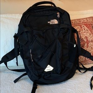 black and rose gold north face bookbag